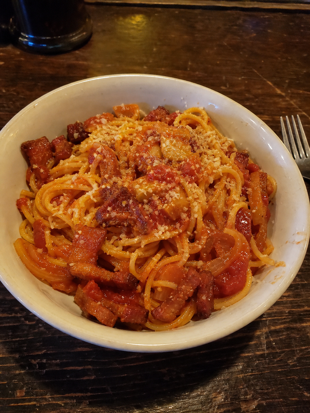 Amatriciana pasta with tomato sauce, bacon, onion and parmesan
