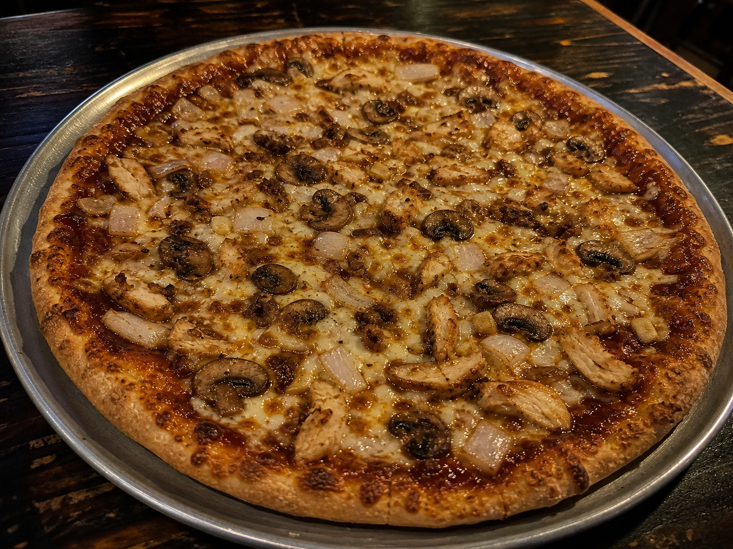 Hand-tossed BBQ Supreme pizza with chicken, onion, mushroom and cheese