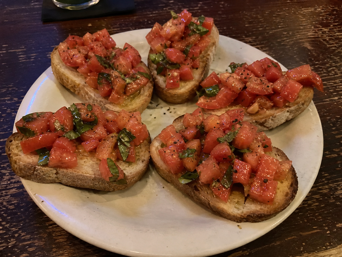Bruschetta with toasted bread, chopped tomato and basil