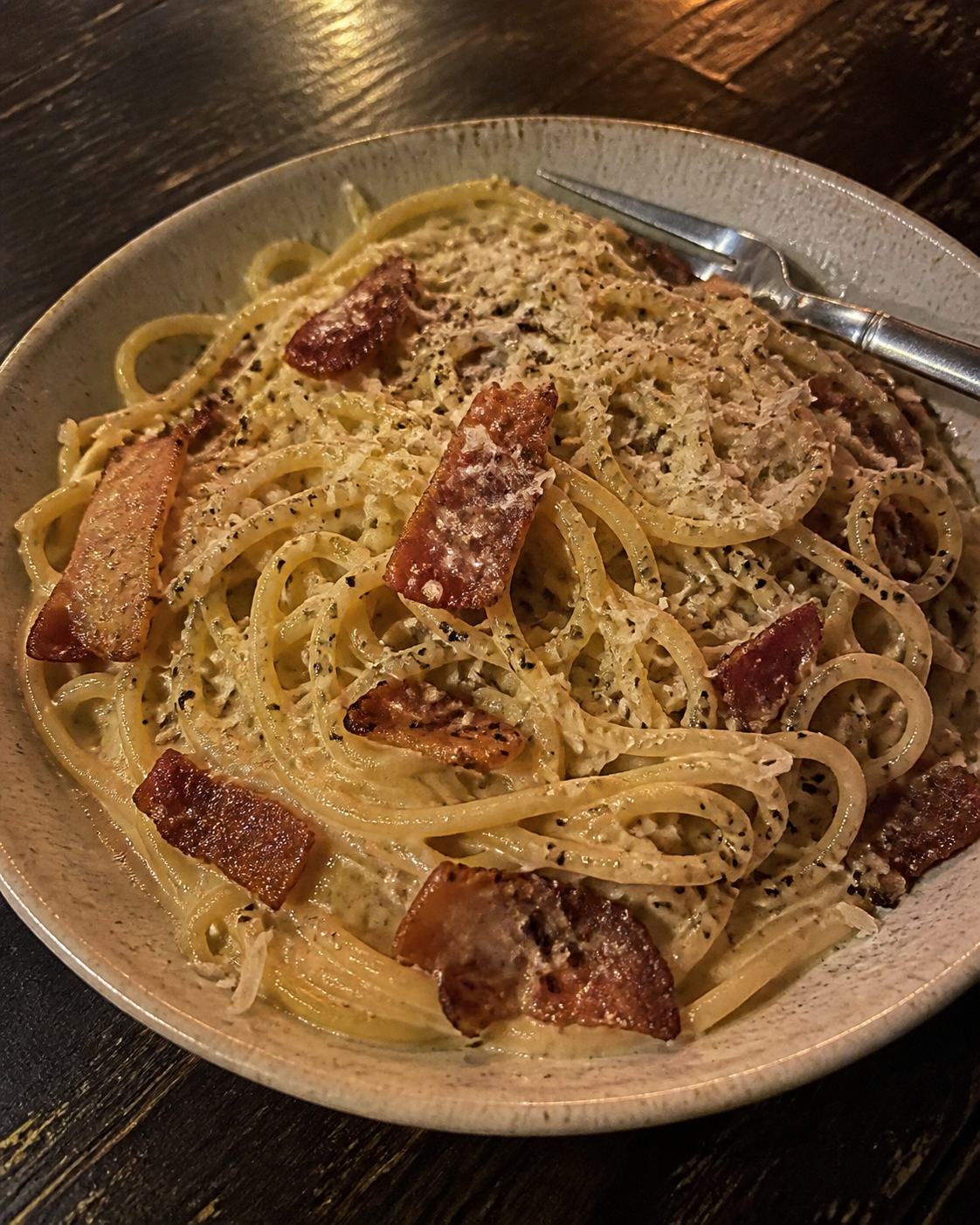 Bacon carbonara with creamy sauce, parmesan and black pepper