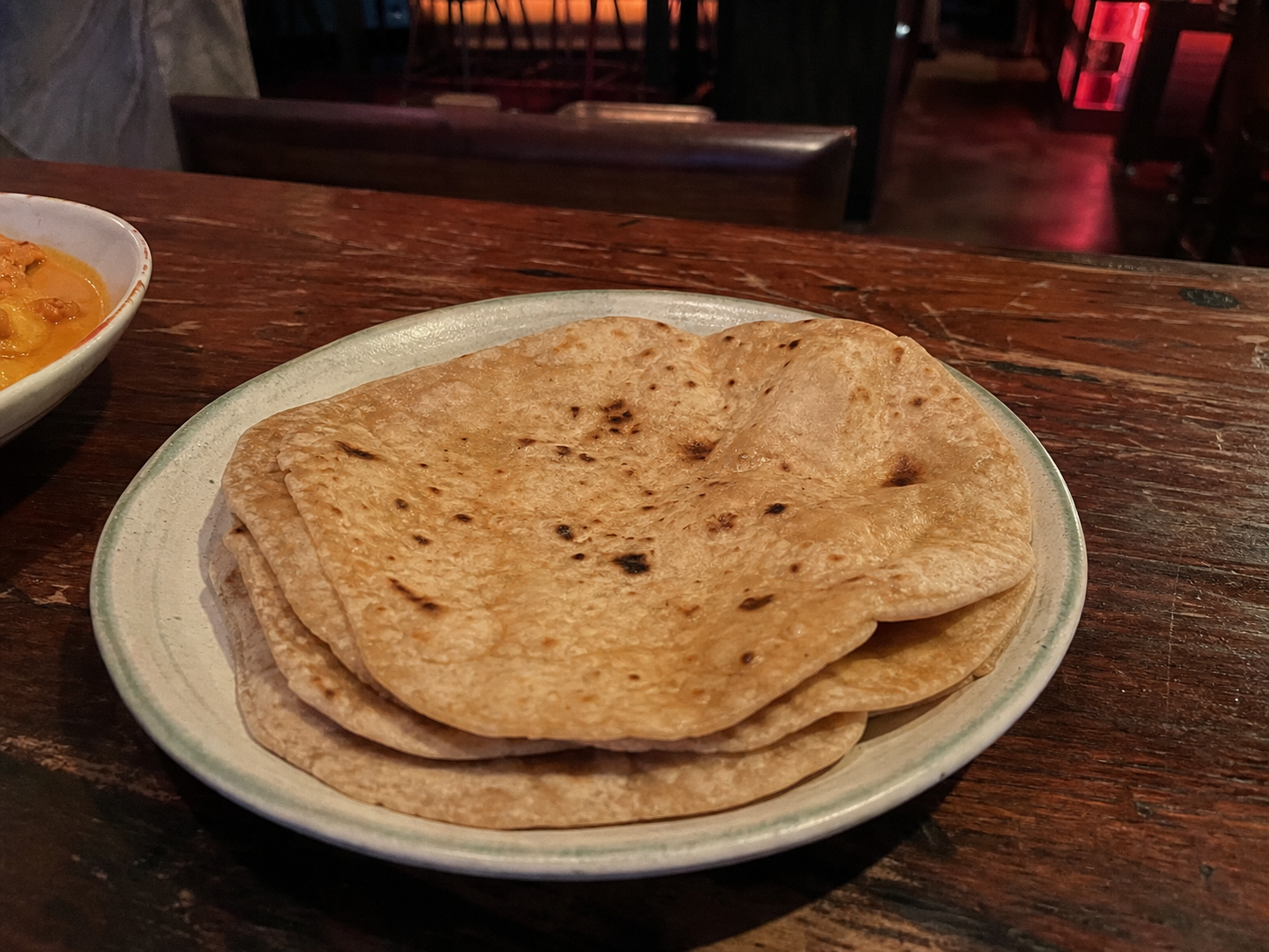 Stack of whole-wheat chapatis with tandoor-style marks