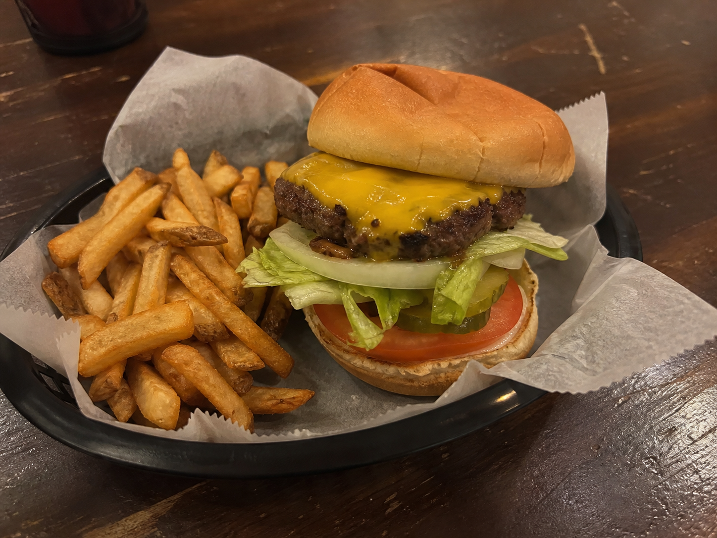 Classic cheeseburger with lettuce, tomato, pickles and fries