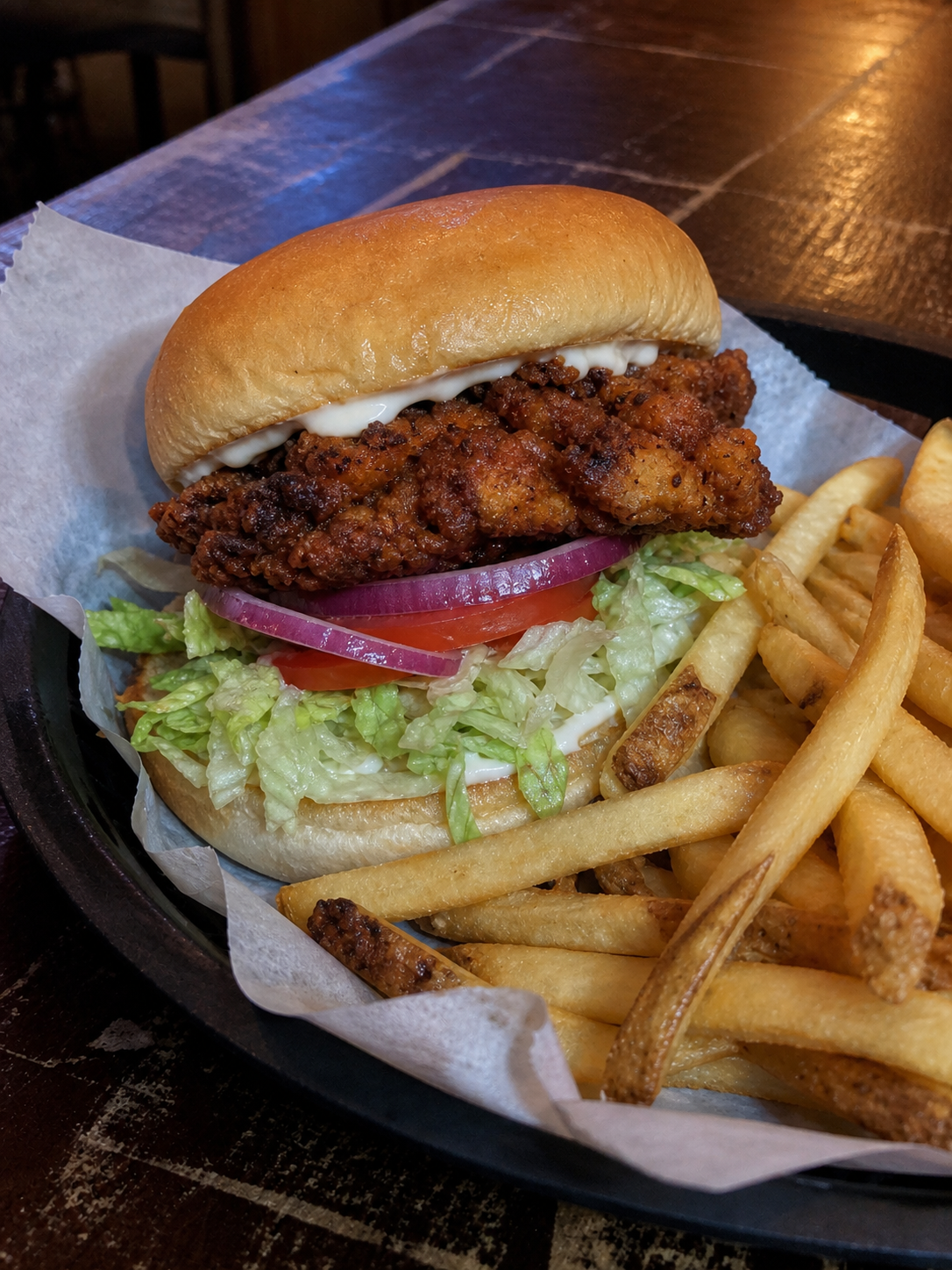Crispy chicken burger with lettuce, tomato, onion, mayonnaise and fries