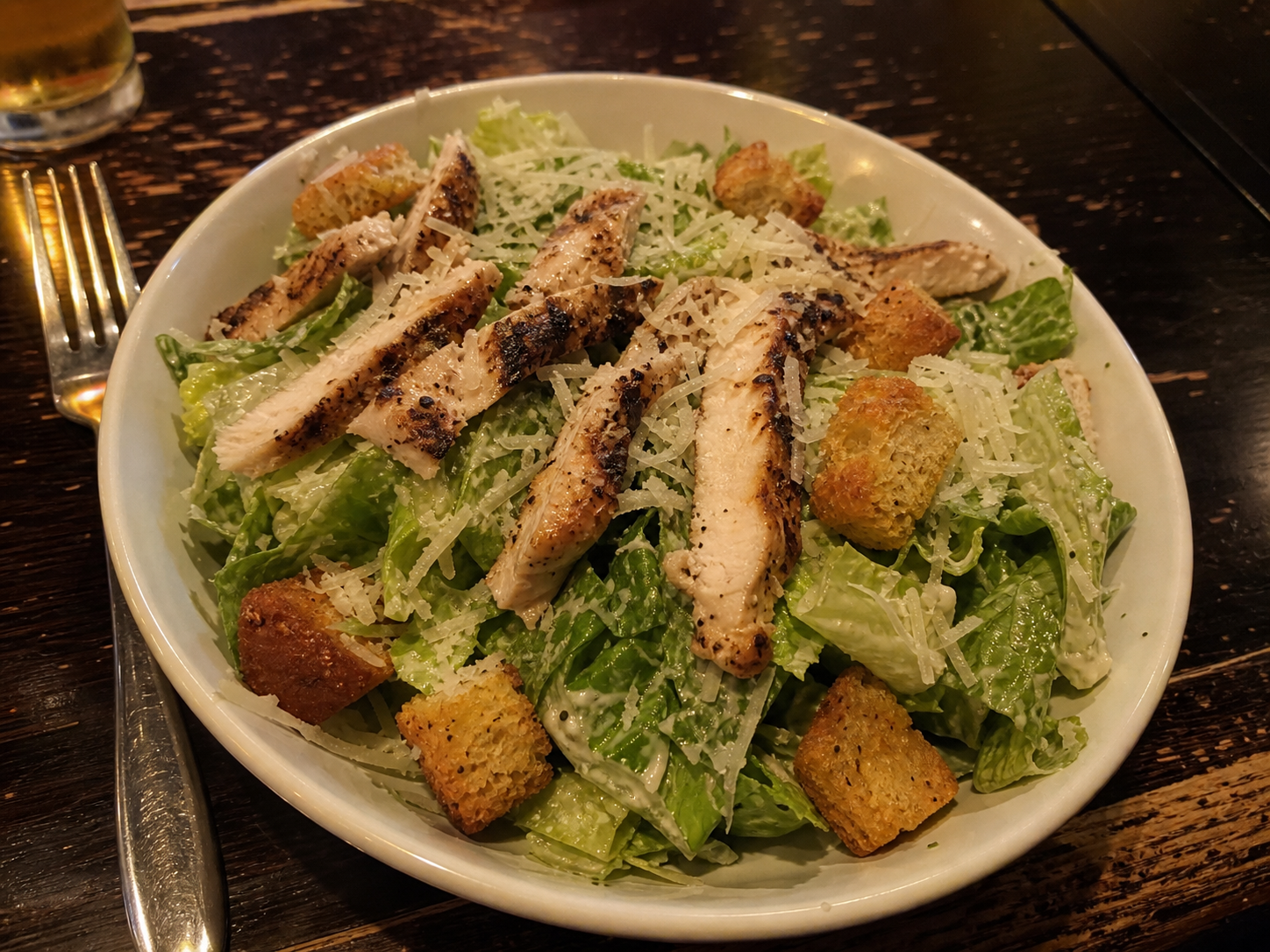 Chicken Caesar salad with romaine, grilled chicken, parmesan and croutons
