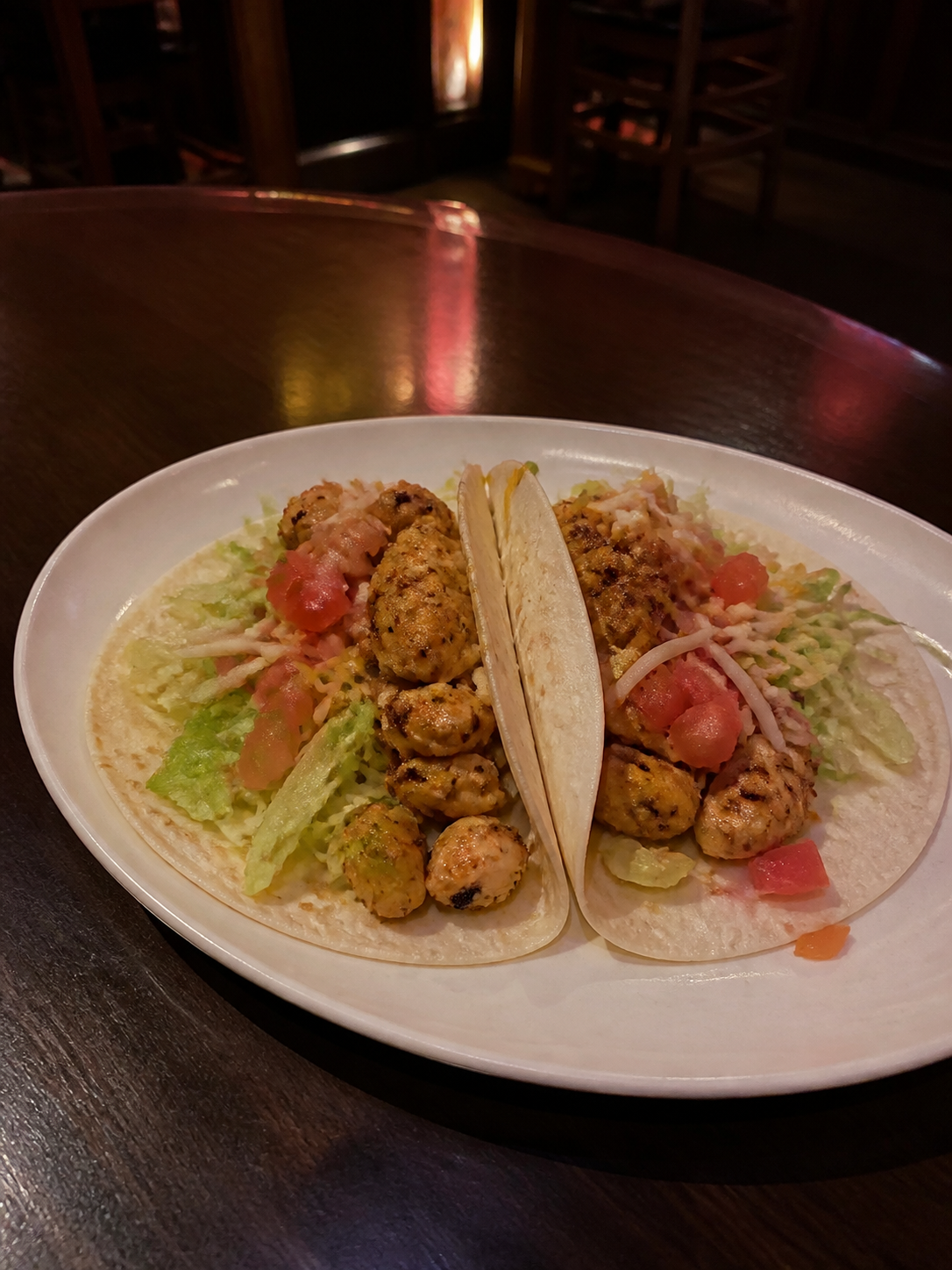Soft chicken tacos with lettuce, tomato, onion and cheese