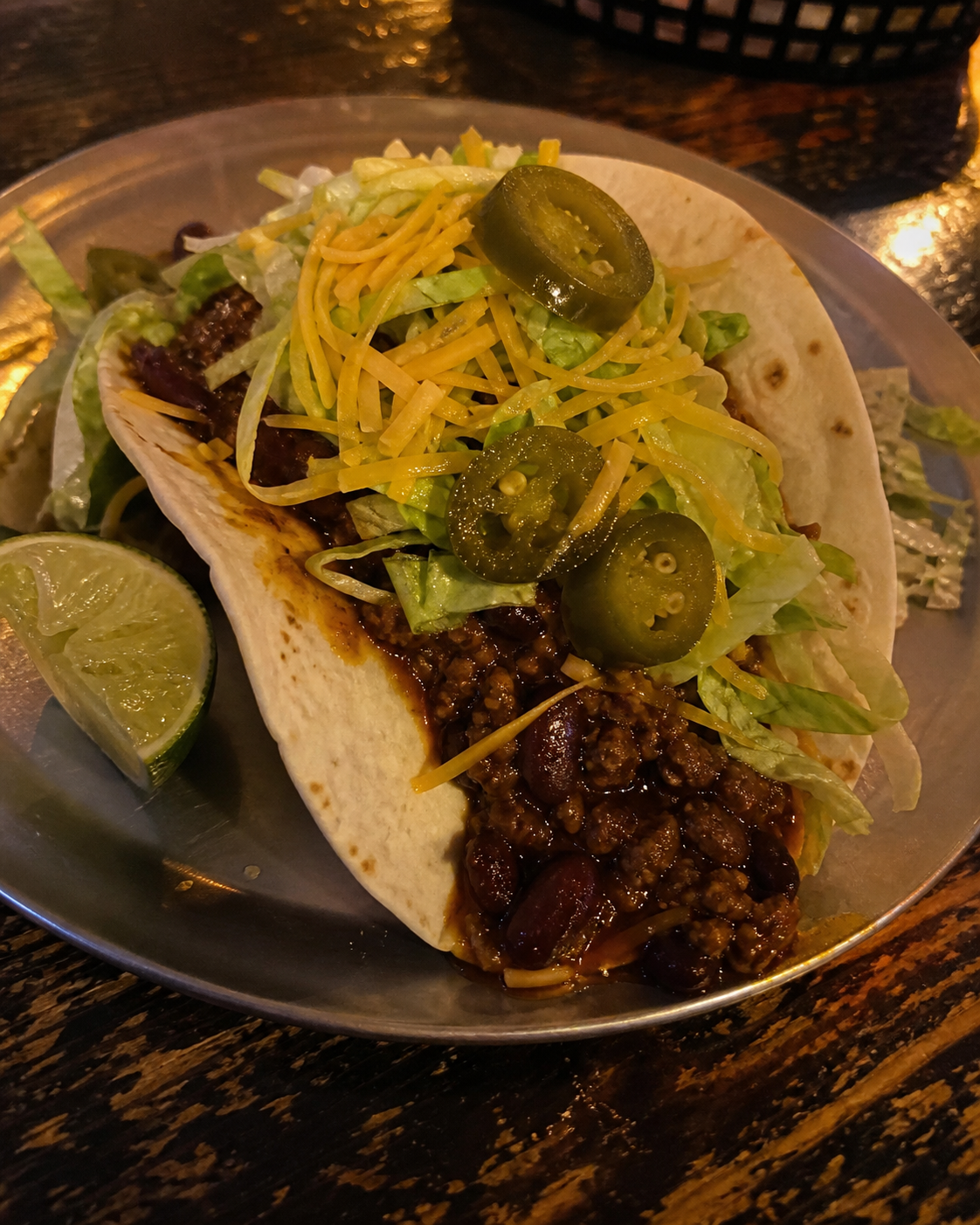 Spicy chilli con carne taco with jalapenos and cheese