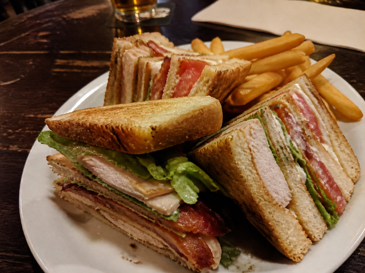 Club sandwich with chicken, bacon, lettuce, tomato and fries
