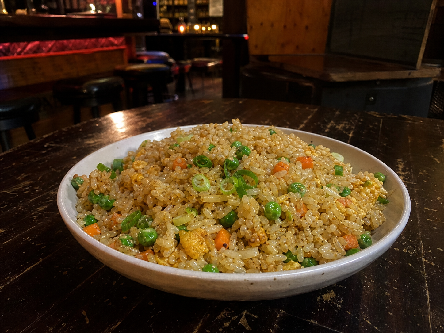 Wok-fried rice with egg, peas, carrot and spring onion