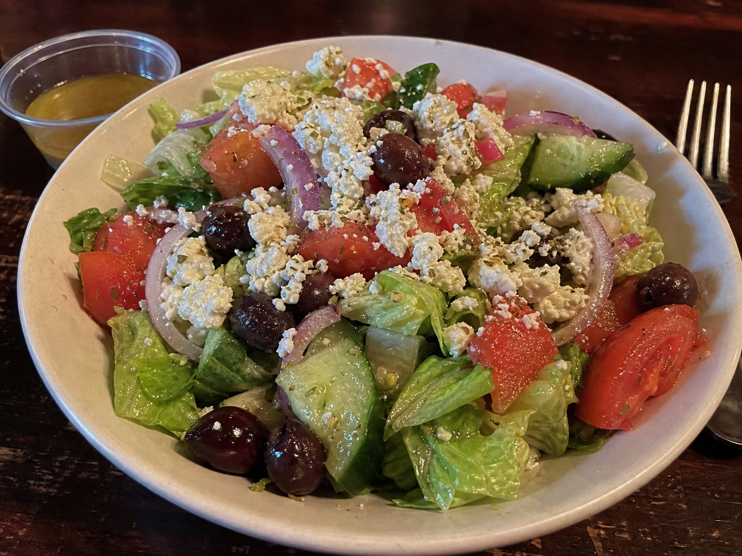 Greek salad with tomato, cucumber, olives, red onion and feta