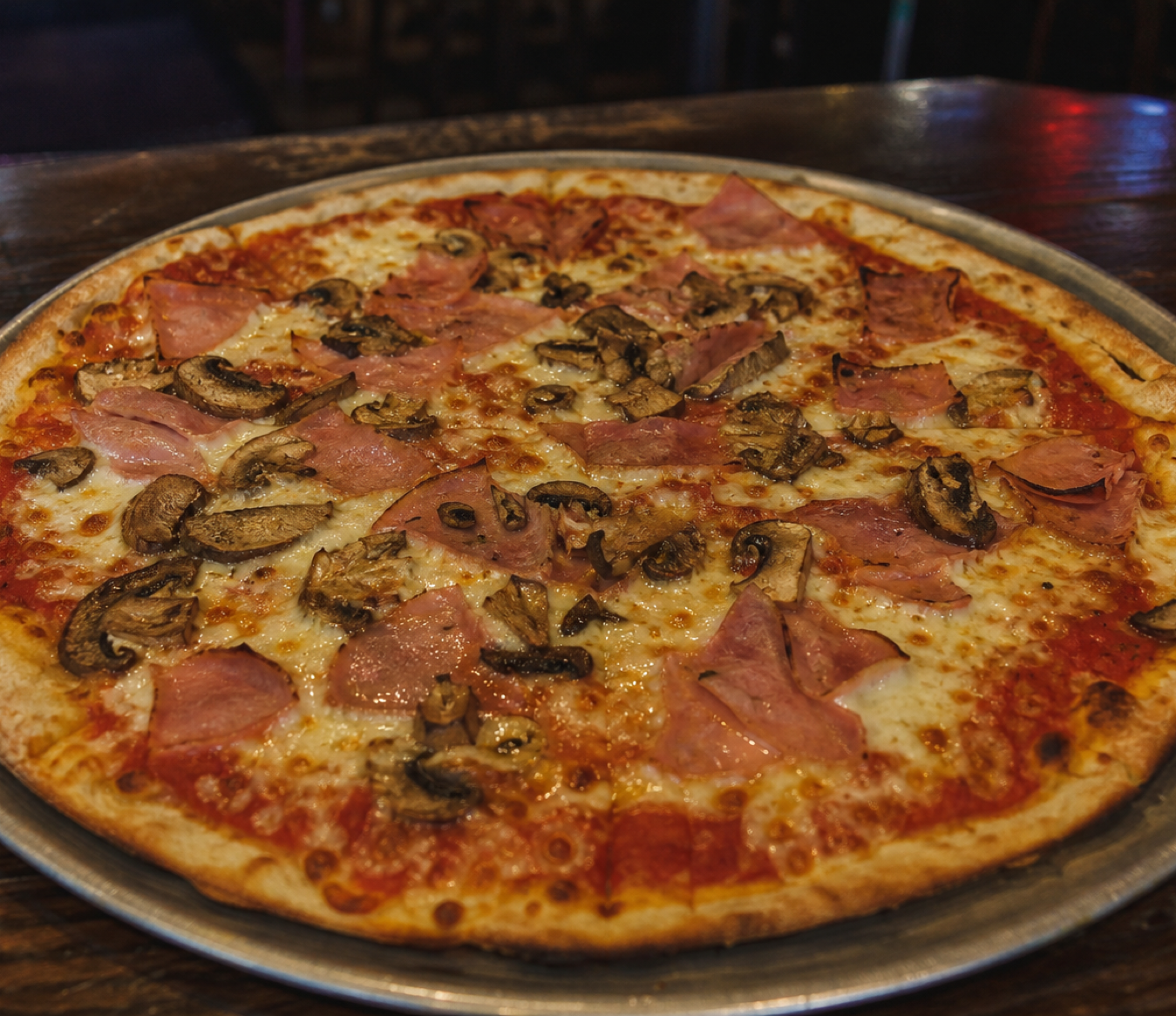Hand-tossed ham and mushroom pizza with mozzarella