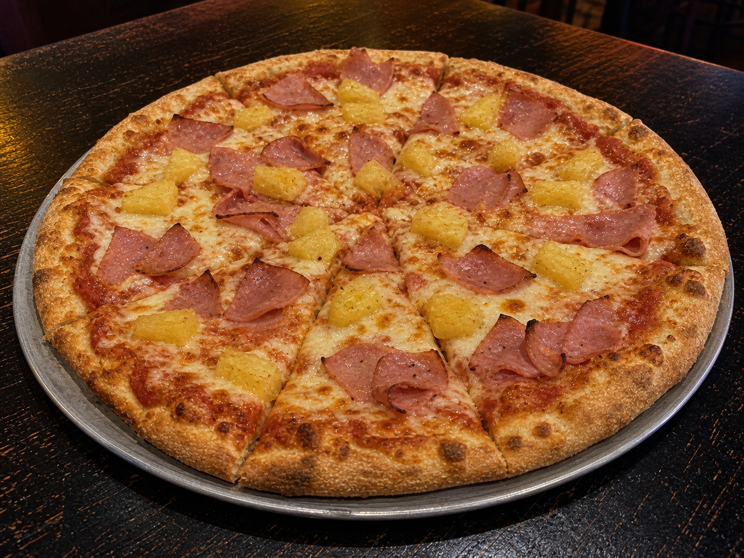 Hand-tossed Hawaiian pizza with ham and pineapple