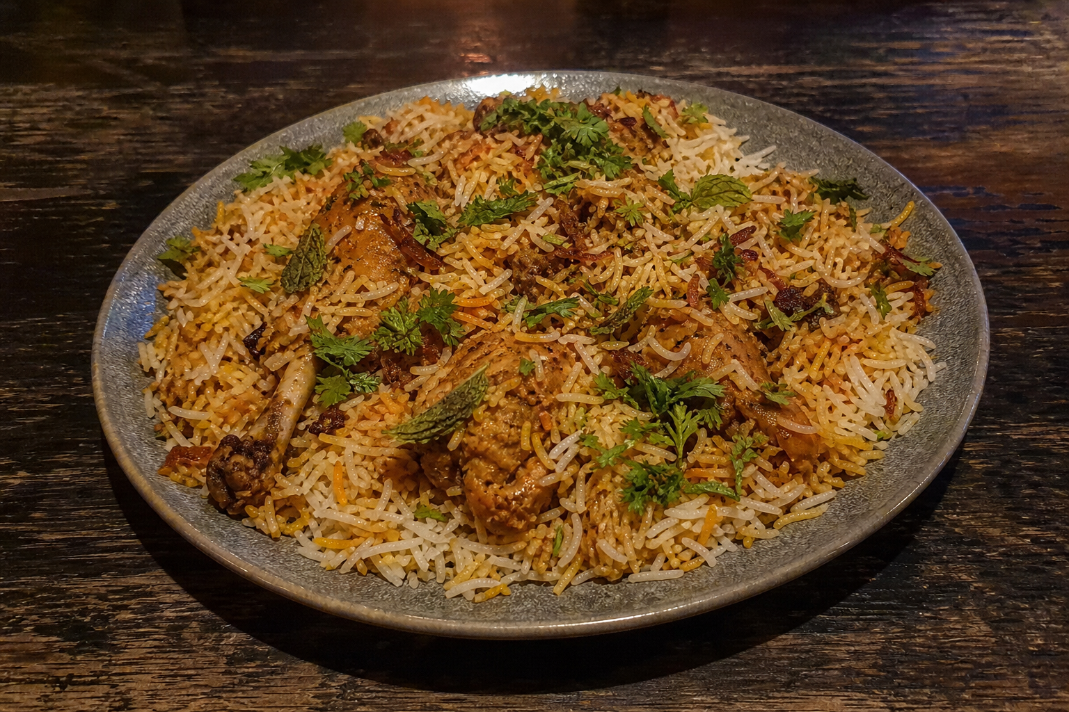 Hyderabadi dum chicken biryani with basmati rice and fried onions