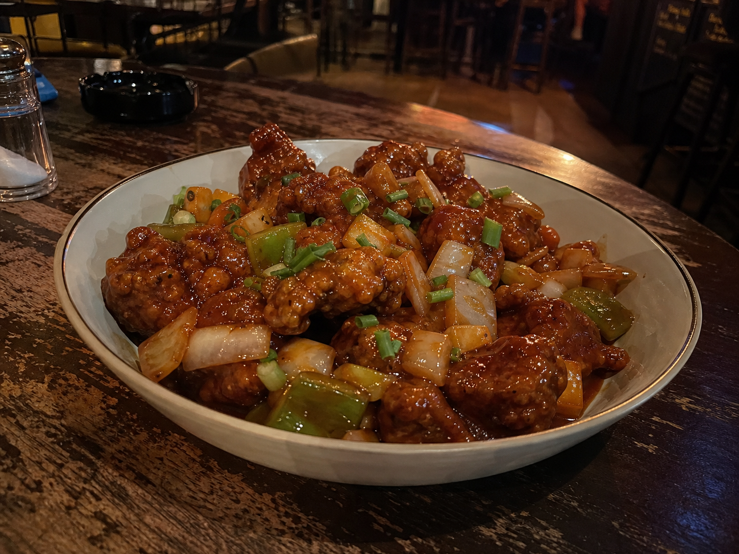 Manchurian pieces with onion, capsicum and spring onion