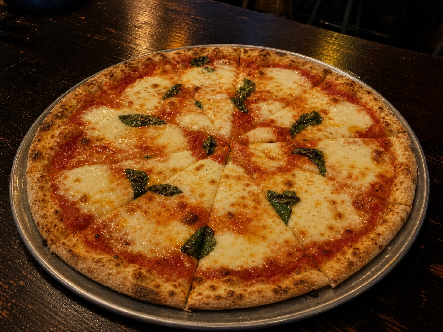 Hand-tossed Margherita pizza with tomato, mozzarella and basil