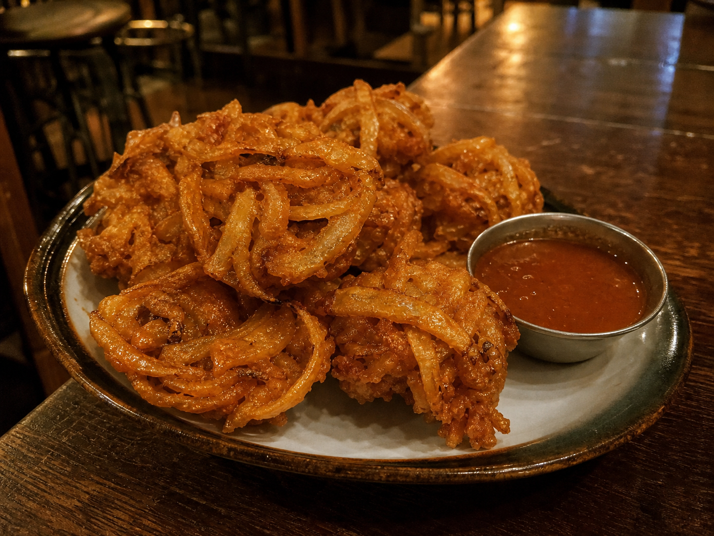 Crispy onion pakora fritters with dipping sauce