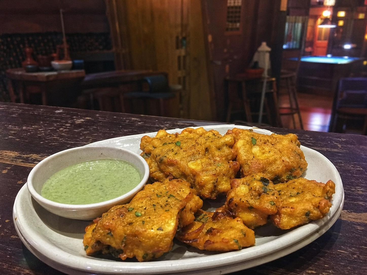 Crispy paneer pakora fritters with dipping sauce