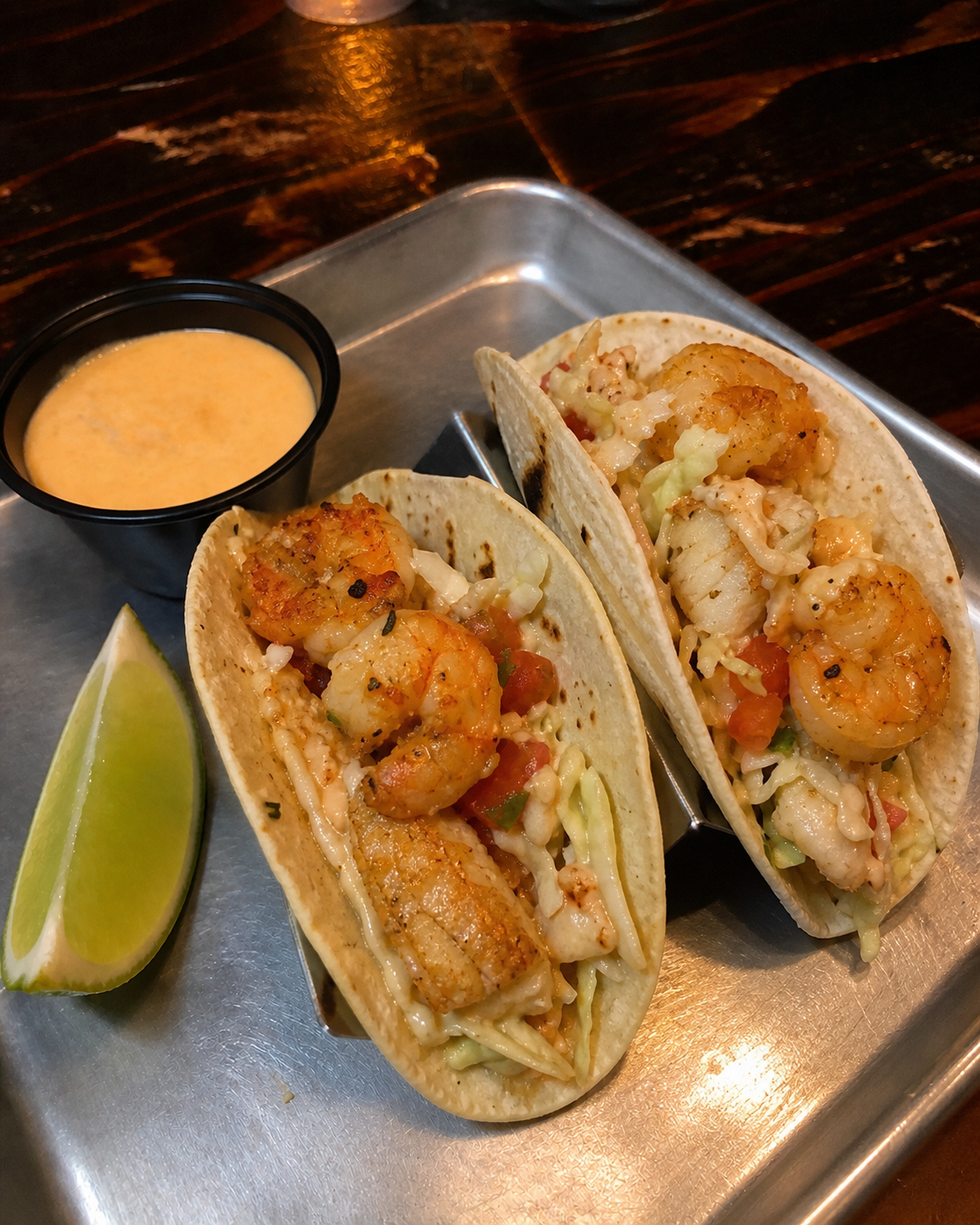 Soft seafood tacos with shrimp, flaky fish, cabbage and lime