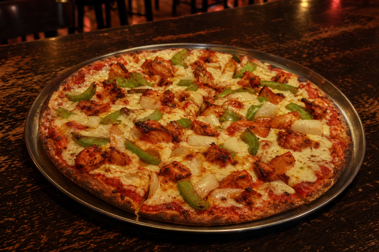 Hand-tossed Tandoor Chicken pizza with grilled chicken, peppers and onion