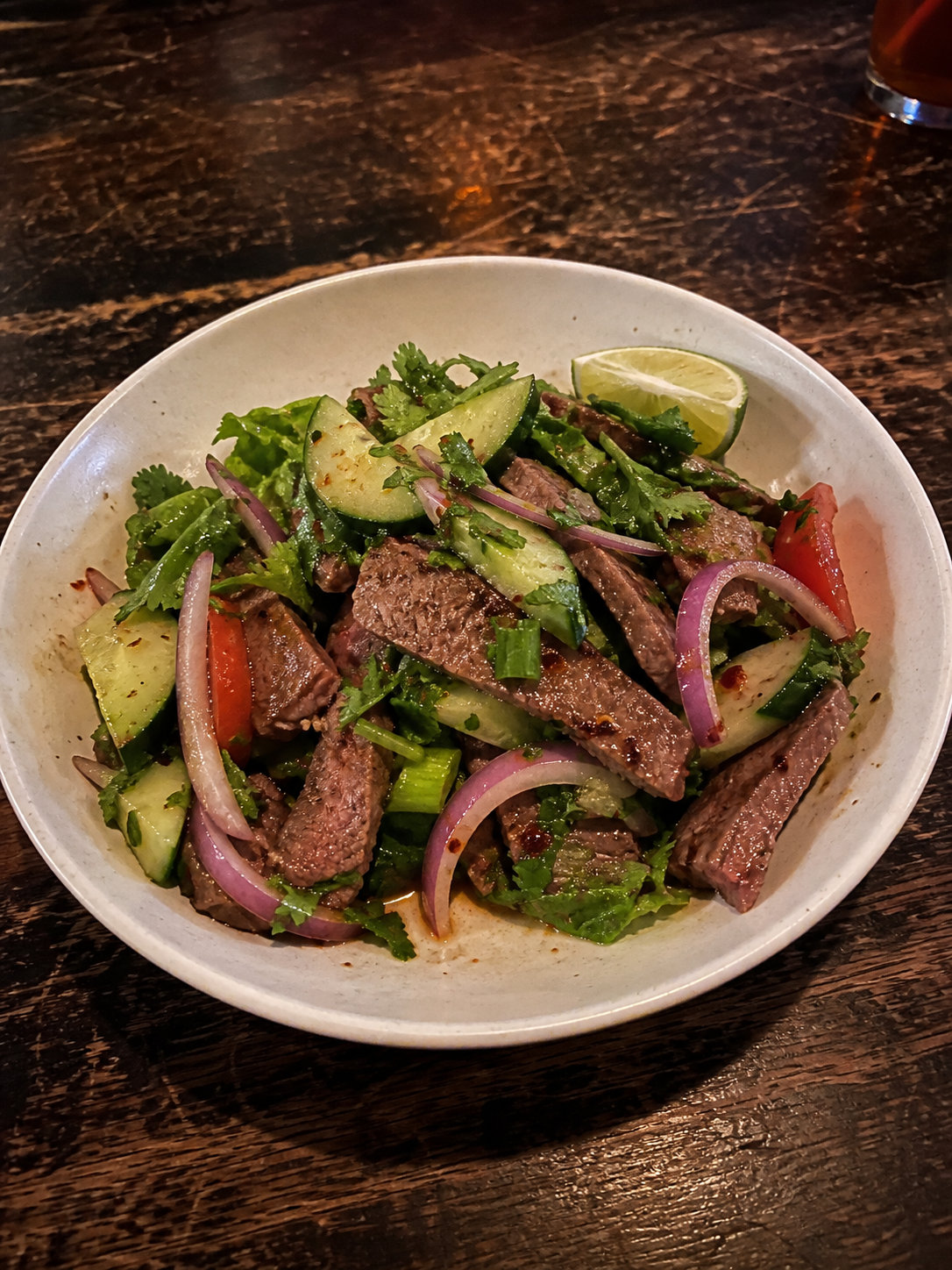 Thai beef salad with grilled beef, cucumber, herbs and lime