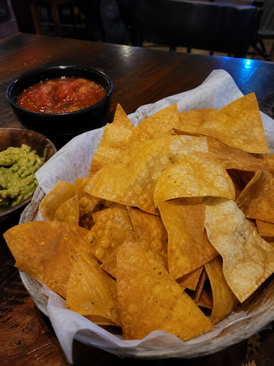 Homemade tortilla chips with salsa and guacamole